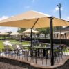 A square hip shade is a type of shade structure that features a square canopy with four sloping sides.